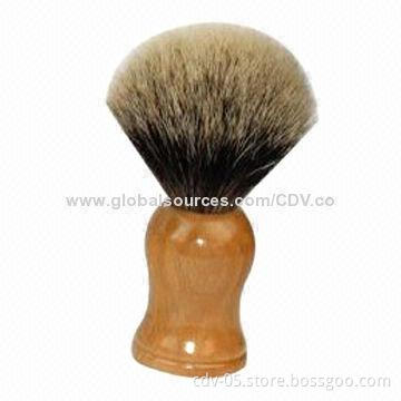 Shaving brush with wooden handle and badger bristles tip
